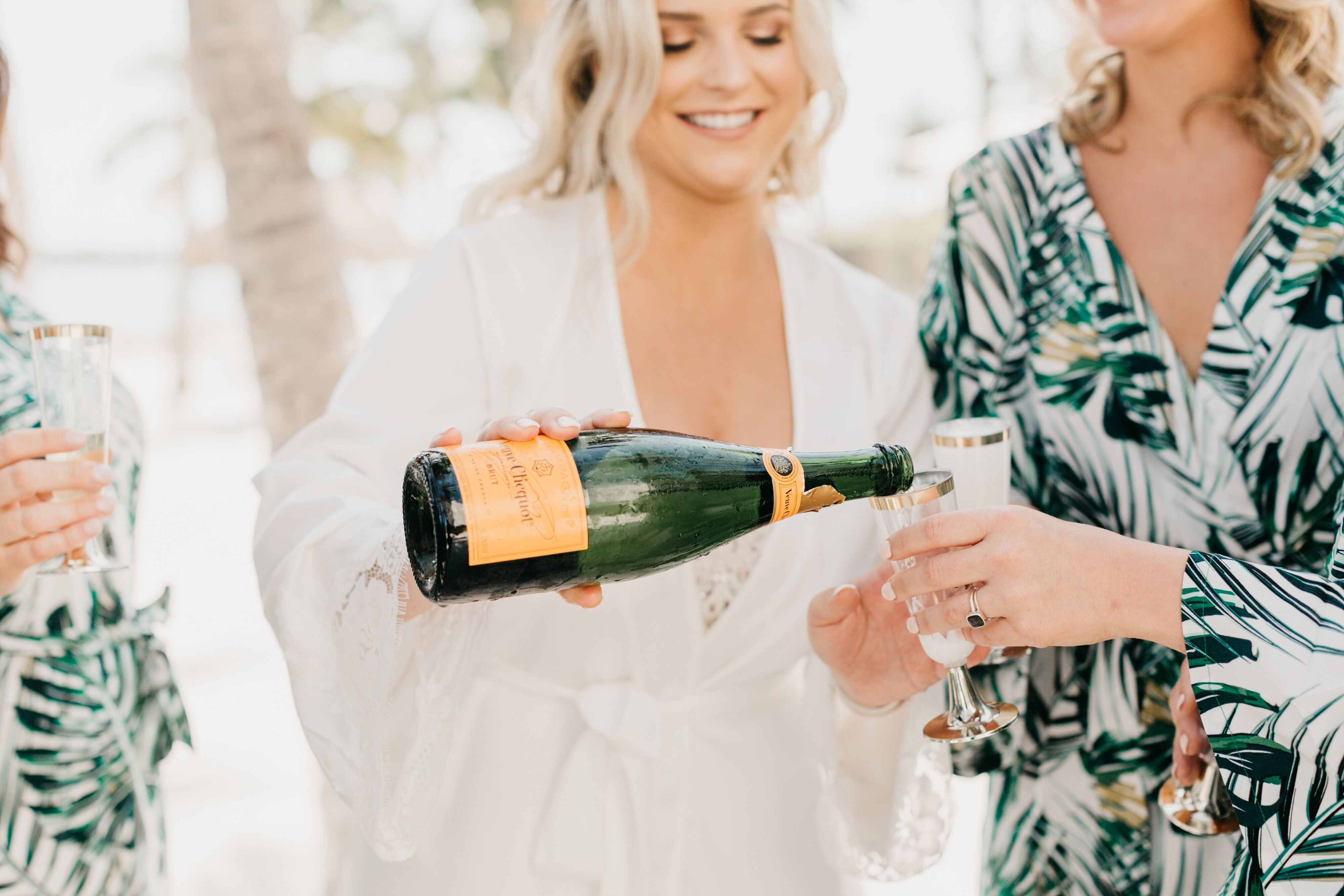 Bride Pourning Veuve Champagne with Her Bridesmaids